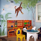 Muhammad Playroom 1 of 2 - A play kitchen and game table with animal chairs create a wonderful space for creative play and complement the jungle look.