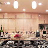 Bushman Kitchen 3 of 5 - The large pantry allows for lots of storage. The pendant lights over the island are a beautiful textured glass. The pendants and recessed cans throughout the kitchen are on different switches, and all are on dimmers, allowing for a multitude of lighting mood options.