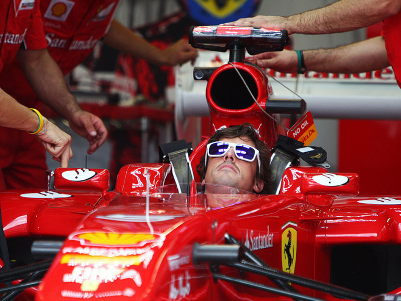 Фернандо Алонсо смотрит за механиками Ferrari на Гран-при Канады 2011