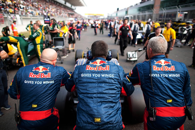 механики Toro Rosso толкают болид по стартовой решетке Йонама на Гран-при Кореи 2012