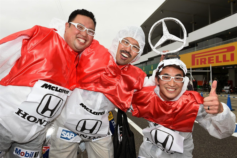 болельщики в бело-красной раскраске McLaren Honda на Гран-при Японии 2014
