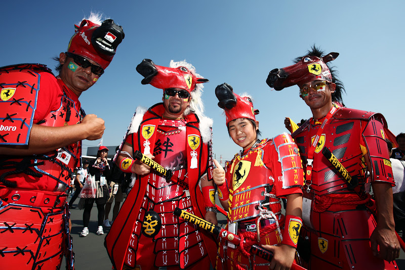 болельщики Ferrari в боевых костюмах красной команды на Гран-при Японии 2011