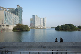 two people sitting at Nam Van Lake in Macau