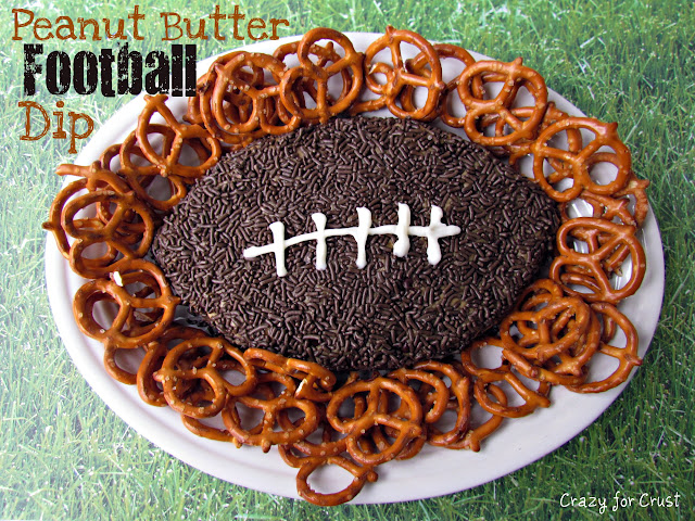 Peanut butter football dip on a white plate with pretzels surrounding it