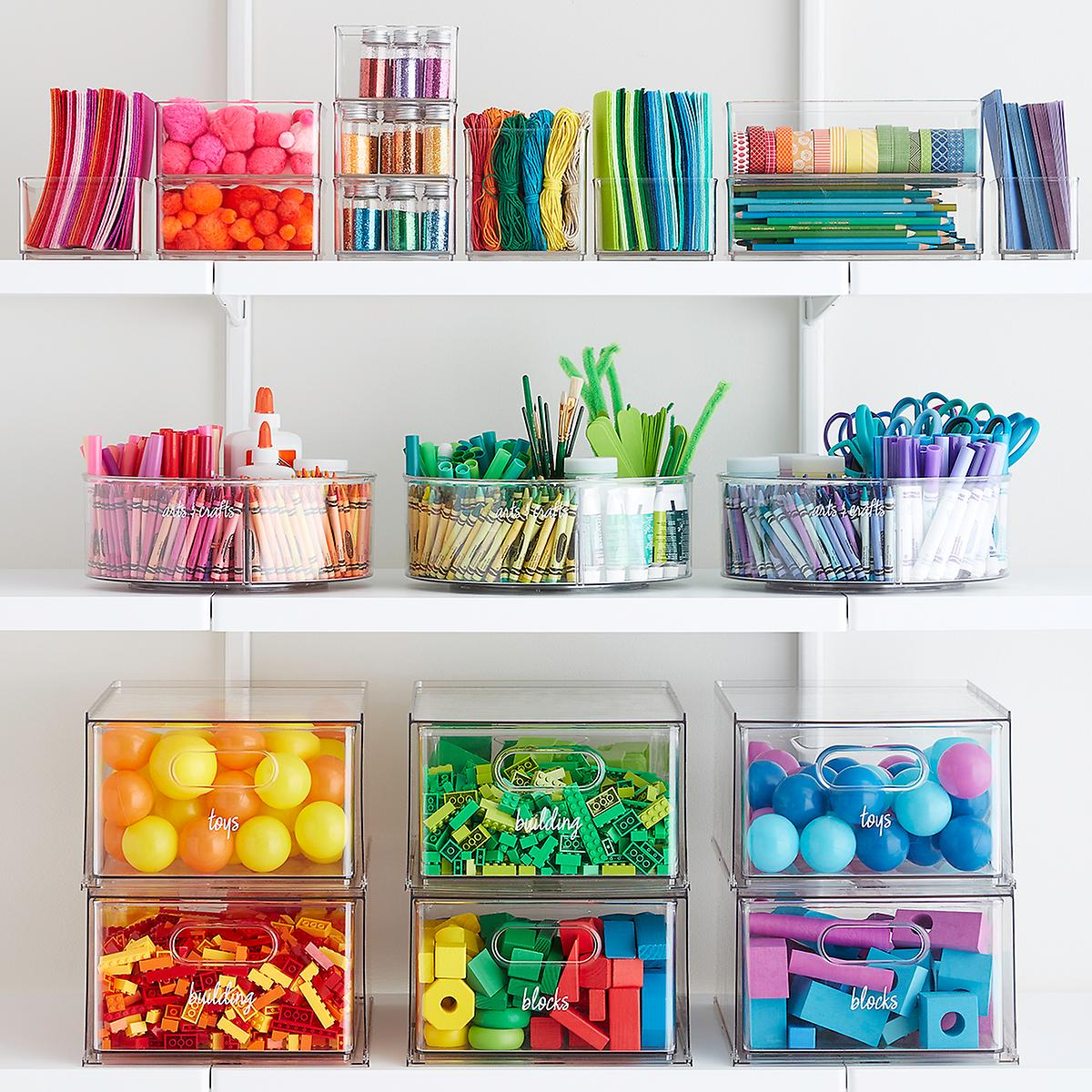 The Home Edit craft system- clear bins filled with crafts organized in ROYGBIV color order. Bins filled with crayons, cotton balls, construction paper and more.
