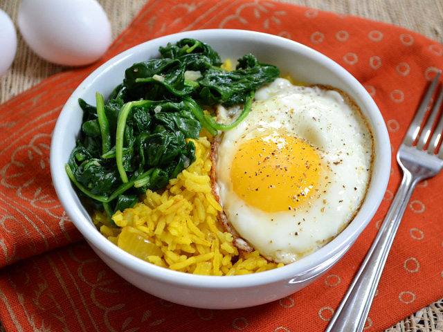 Top view of a Golden Rice Bowl with a fork on the side 