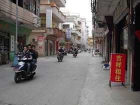 three young men riding a motorbike in Yangjiang, China