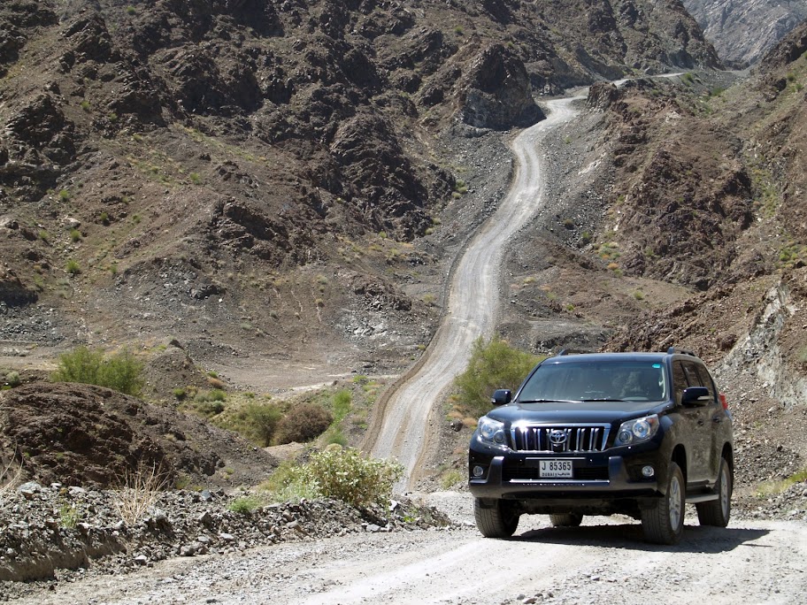 A Toyota Prado negotiates the steep but well-maintained track on the way to Wadi Jazira.