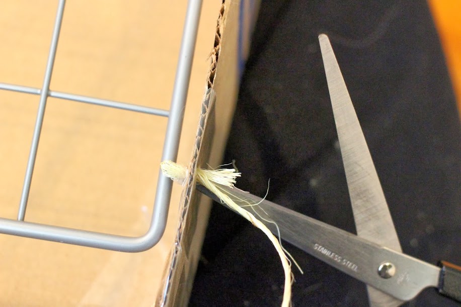 top view of pushing string through with scissors