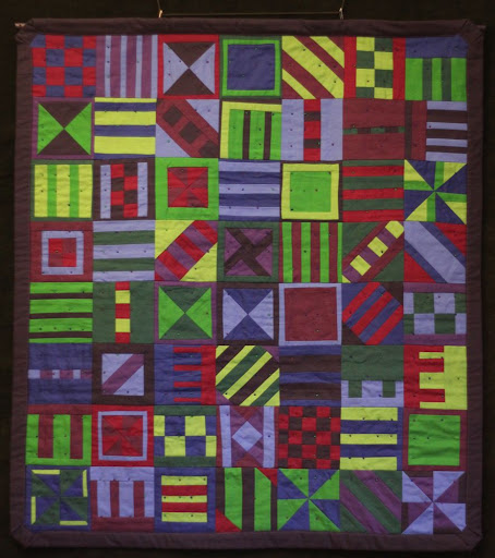 a wall quilt in blues, purples, and greens