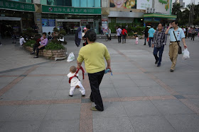 kid on leash with open pants in Zhuhai, Guangdong