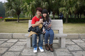 young couple siting on park bench in Zhuhai