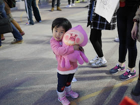 little girl hugging a stuffed toy
