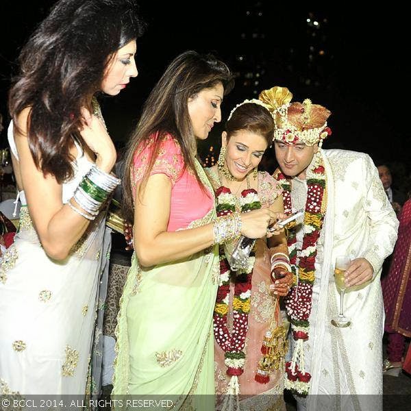 Queenie Singh with the bridal couple Raageshwari Loomba and Sudhanshu Swaroop during their wedding, held in Mumbai, on January 27, 2014.