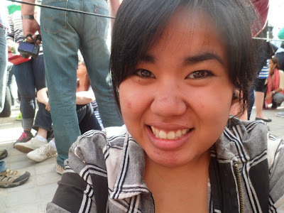 A photo of Justher smiling, waiting for the Louvre to open