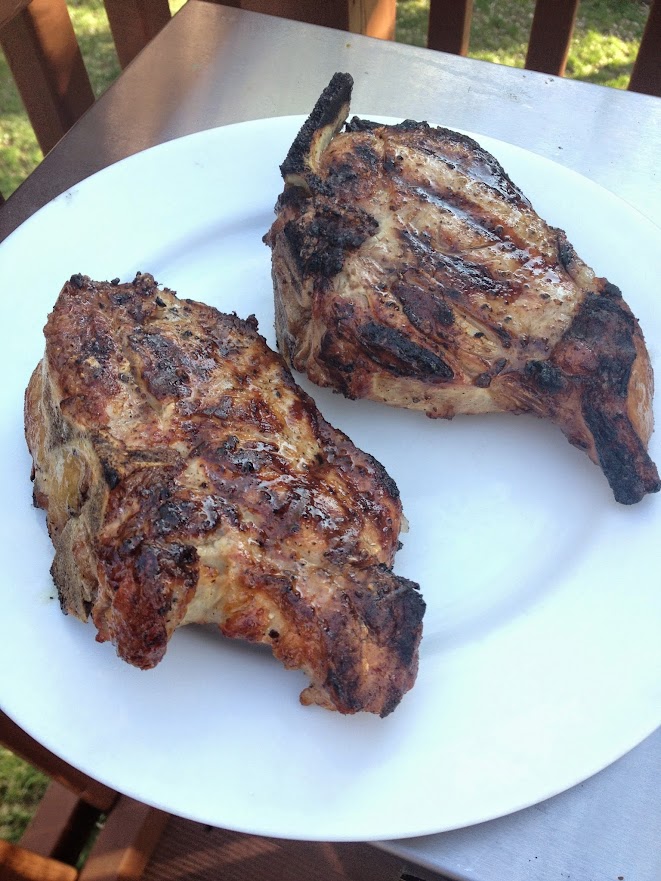 Grilled veal chops are easy to prepare on an outdoor grill and feature Kosher salt and freshly cracked black pepper with eggplant as a side dish