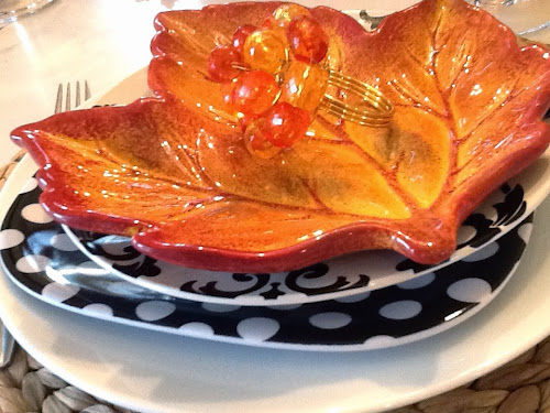 Fall leafy tablescape with black and white dishes and leaf plate