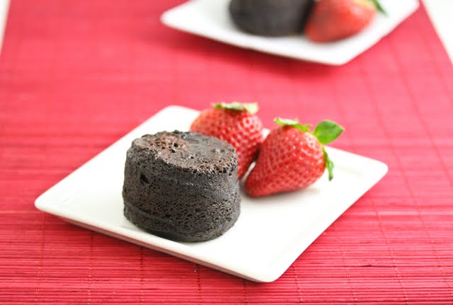 photo of a small flourless chocolate cake on a plate