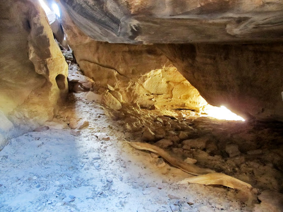 Going between the boulders leads one here. I'd guess this was a nice shelter once. The hole on the right spits you back out near the rock art.