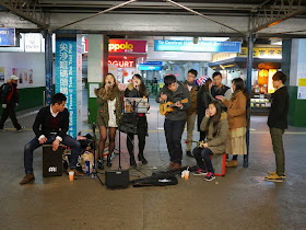 music group performing in front of the Star Ferry Pier