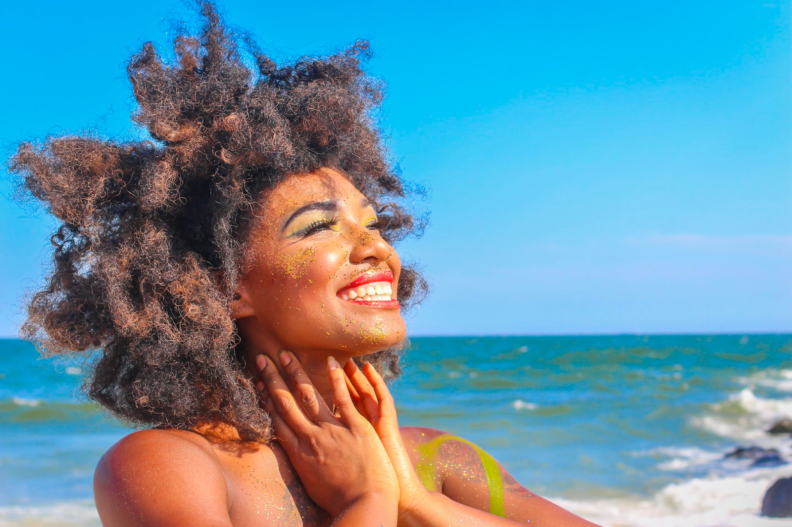 A young woman catching some rays on the beach on a hot summer day