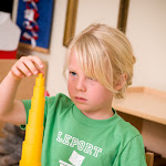 Preschool girl in Huntington Beach Montessori school working with knobless cylinder sensorial material.