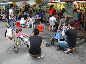 man talking to girl in a stroller