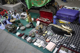 saxophone, trumpet, watches, and other items for sale outside Tianxinge Antique City in Changsha, China