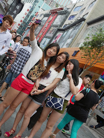 three young women talking a selfie at Dongmen