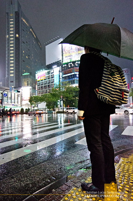Suits and Backpack at Tokyo's Shibuya Crossing