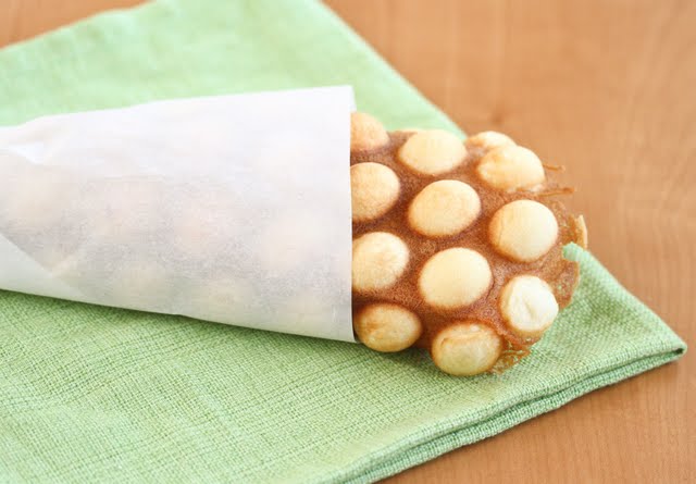 paper-wrapped egg waffle on a green napkin