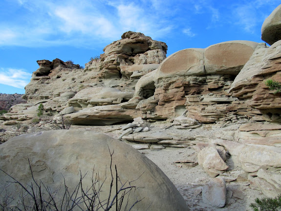 Half-circle of sandstone (bottom-left) that cleaved off another formation (upper-right)