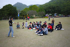 group watching man with nunchaku at Bailian Dong park in Zhuhai China