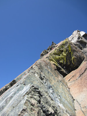 Looking up at the corner of the face from the bottom of the second rappel.  Sara went to the corner up higher near the colorful lichen so she didn't have to traverse across the green rock face