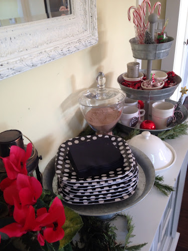 Set up a Hot chocolate bar with mugs, black and white plates and toppings