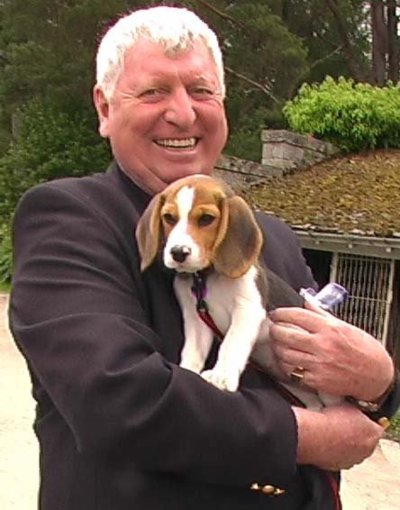 Tom Baker holding a puppy