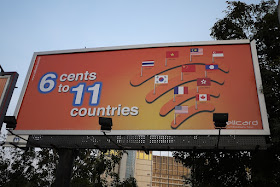 billboard reading "6 cents to 11 countries" with images of flags from 10 countries and Hong Kong