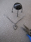 Push twist down into the loop. Use your pliers if you need help forming your hear.
