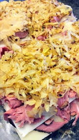 Spread both sides of bread with the Russian Dressing and then the shredded corned beef or pastrami to the bottom half, then layer with Swiss cheese, repeat for your Reuben Sliders, then add your sauteed sauerkraut