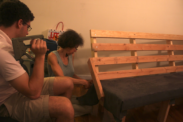 mother and son teamwork to upholster the faux suede