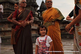 Cute kid surrounded by colourful ladies