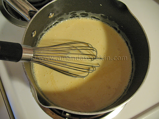 An overhead photo of sweetened condensed milk and orange juice in a heavy bottomed saucepan. 