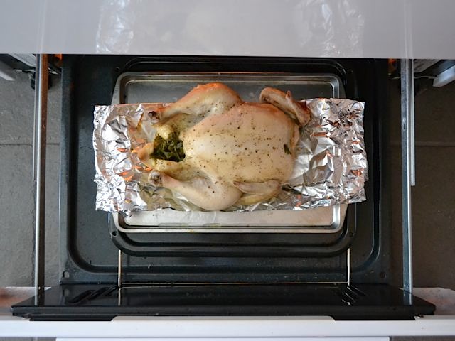 chicken on baking sheet placed in over to broil 