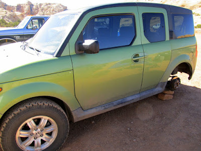 Honda Element minus one of its BFG All-Terrains