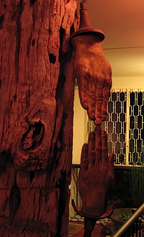 sculpture of two hands on driftwood at Tatung's Garden Café
