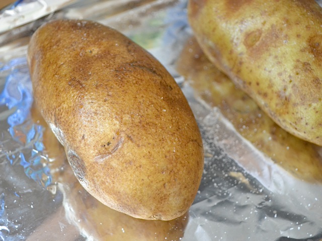 oil and salt rubbed on potatoes ready to cook 