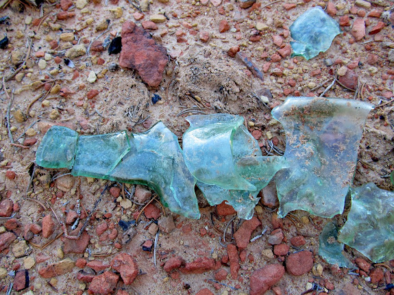 Melted and broken bottle found in an old firepit