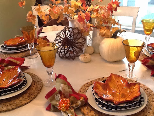 Fall leafy tablescape with white pumpkins and fall leaves