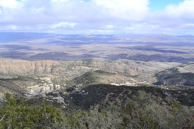 a rocky canyon twisting dwon to the plain