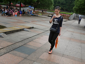 young woman in China wearing a possible knockoff Chanel shirt